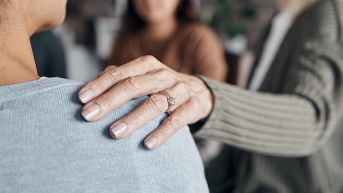 Closeup of a hand on a shoulder