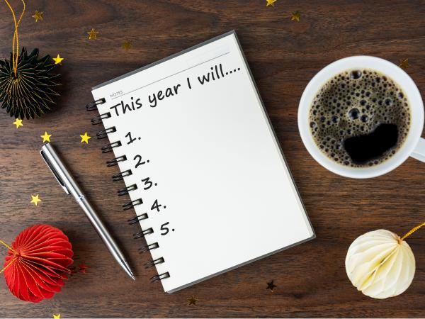 A notebook with an unfinished list of New Year's Resolutions