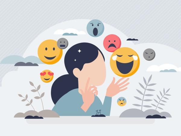 A woman is surrounded by emoji, representing the emotional spectrum