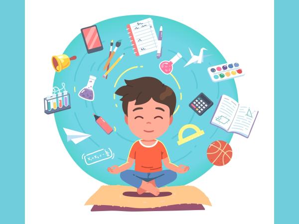 A child at a school desk surrounded by school-related objects